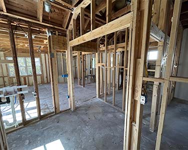 The interior framing of a home, pictured before drywall has been hung to cover the walls. Get a new construction phase inspection from Sighthound Home Services